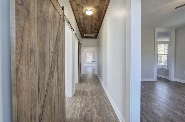 a kitchen with stainless steel appliances granite countertop a sink stove and wooden floor