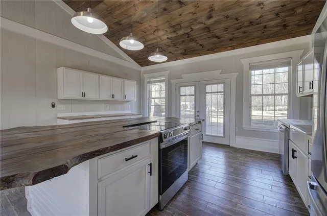 a kitchen with stainless steel appliances a refrigerator and a stove