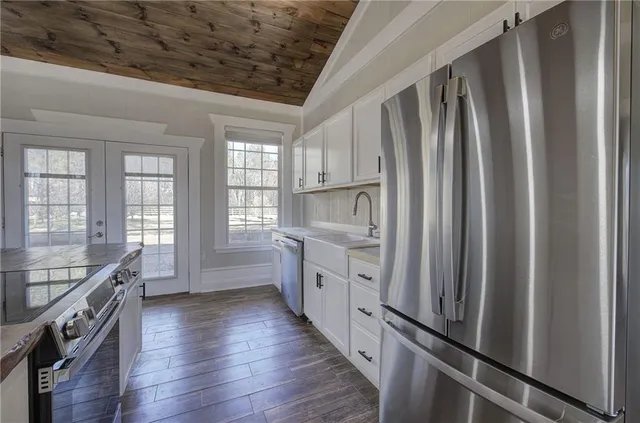 a large kitchen with a stove and large window