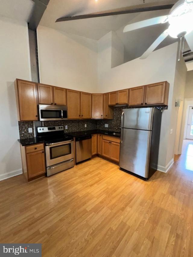 85 Valley Road, Unit 3 Phoenixville, PA 19460 - Photo 9 of 34 a kitchen with stainless steel appliances a refrigerator and wooden floor