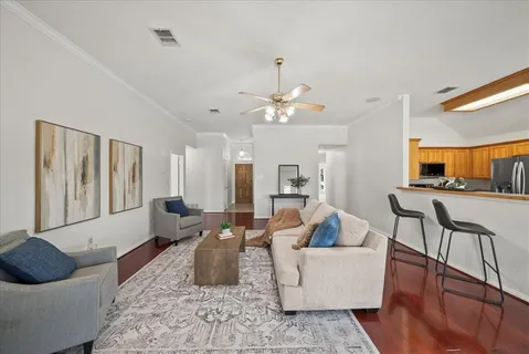 a living room with furniture and wooden floor