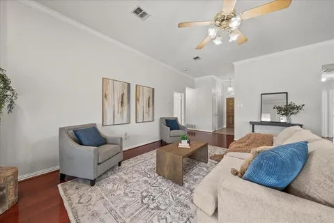 a living room with furniture ceiling fan and a rug
