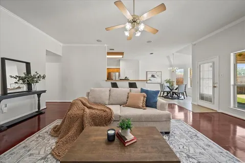 a living room with furniture wooden floor and a rug