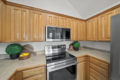 a kitchen with kitchen island a sink table and chairs