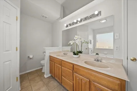 a bathroom with a tub shower and window