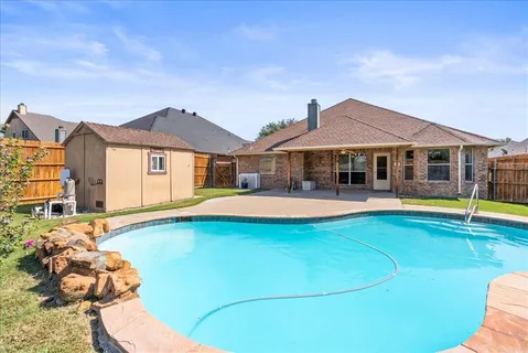 a view of a house with swimming pool and sitting area