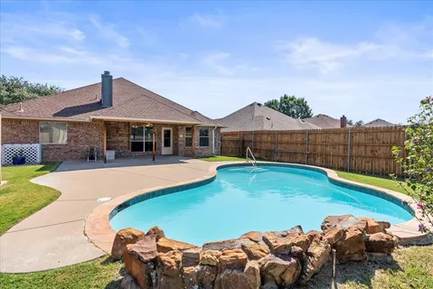 a view of a backyard with a trampoline