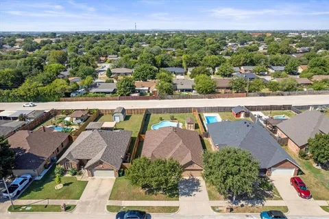 an aerial view of residential houses with outdoor space
