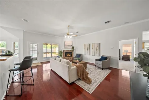 a living room with fireplace furniture and a wooden floor