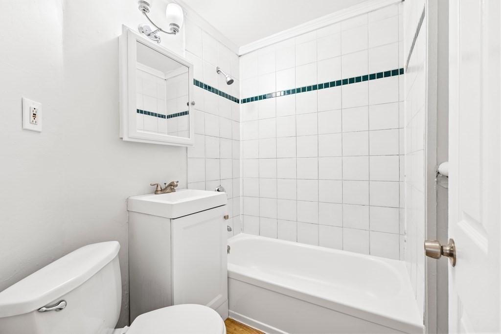 27 Bailey Street Boston, MA 02124 - Photo 11 of 35 a bathroom with a sink a toilet and shower