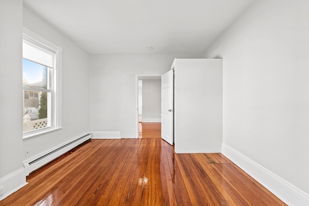 27 Bailey Street Boston, MA 02124 - Photo 23 of 35 a view of empty room with wooden floor and fan