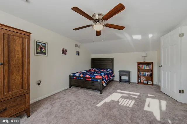 a bedroom with furniture and a fan