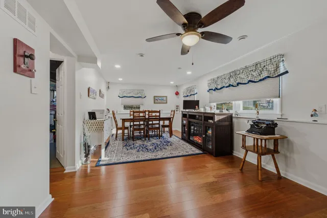 a view of a room with furniture and wooden floor