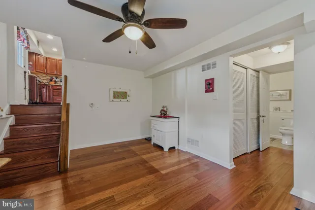 a view of empty room with wooden floor
