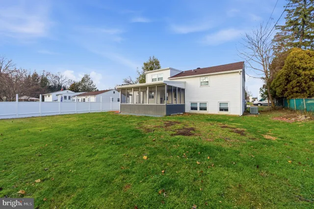 a view of a house with a yard and sitting area