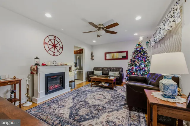 a living room with furniture a rug and a fireplace