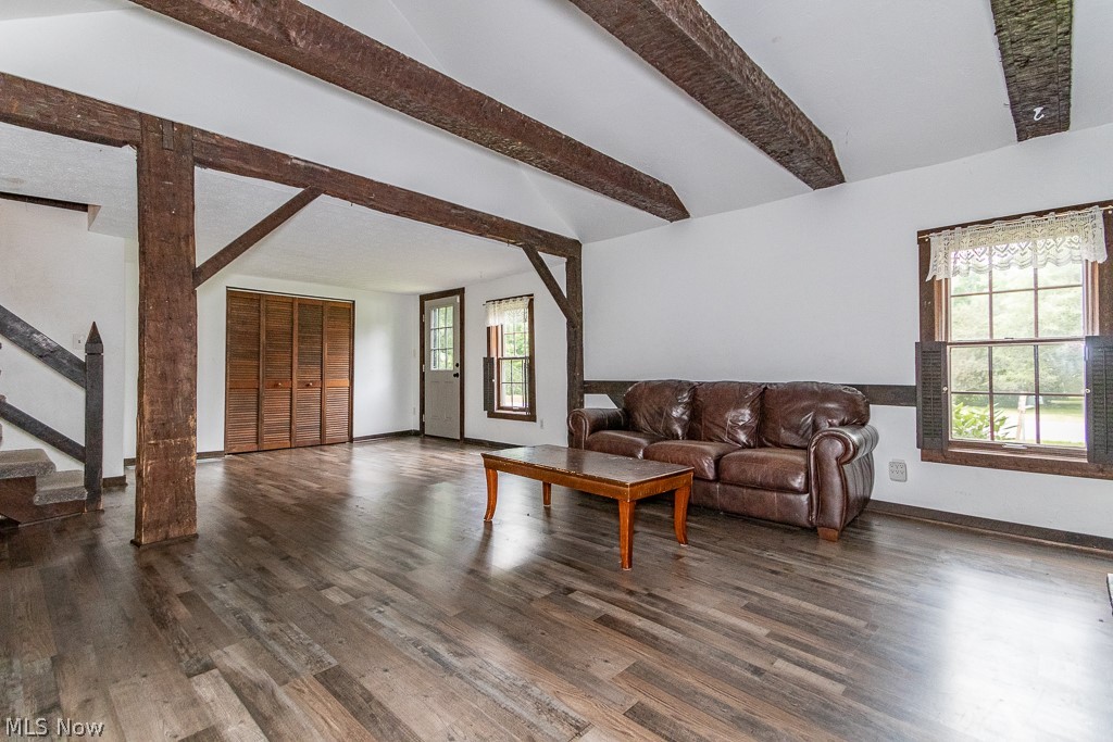 11601 Bass Lake Road Chardon, OH 44024 - Photo 9 of 50 Living room with dark wood-type flooring, lofted ceiling with beams, and a wealth of natural light