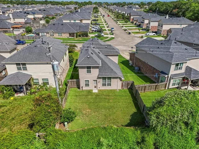 an aerial view of multiple houses with yard
