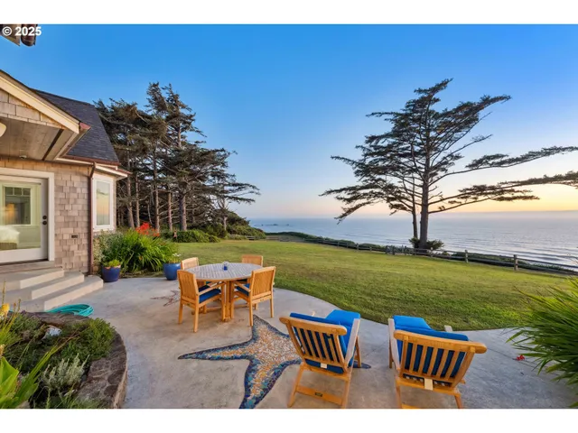 a backyard of a house with table and chairs