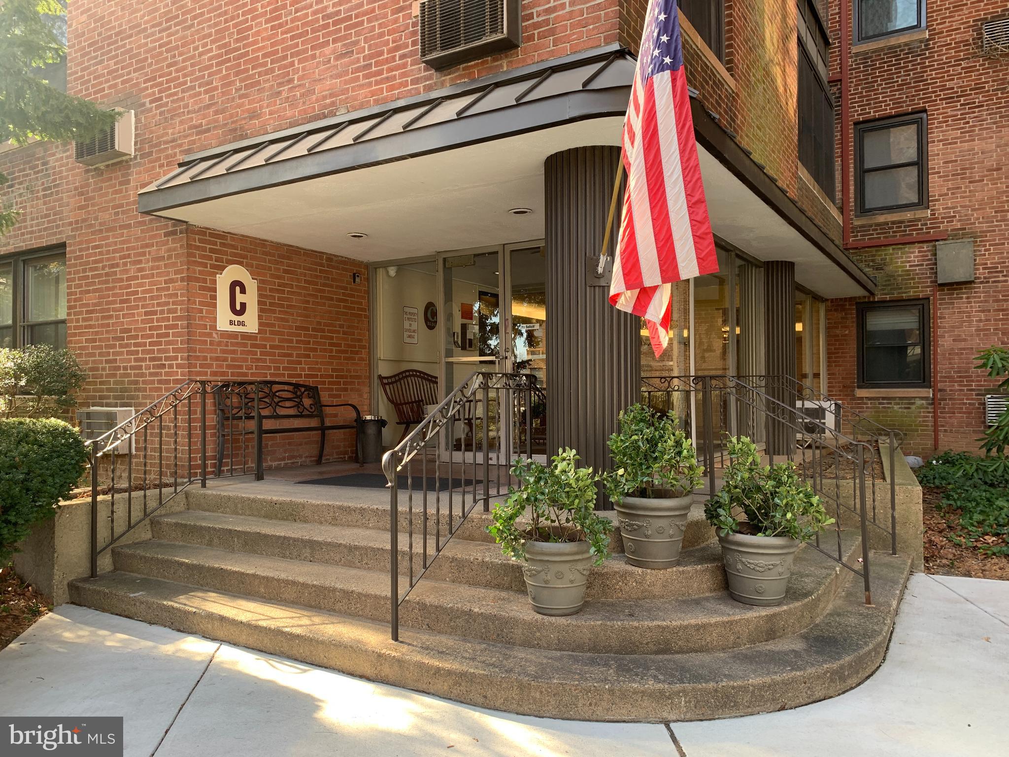 a view of a house with potted plants