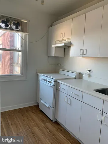 a kitchen with a sink cabinets and appliances