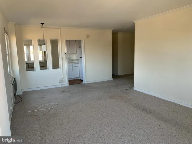 a view of an empty room with a bathroom