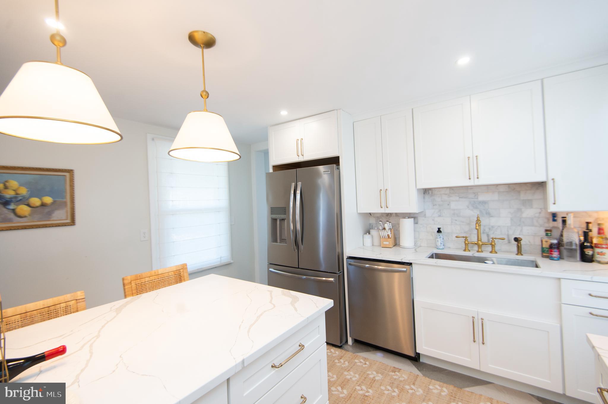 533 South Street Easton, MD 21601 - Photo 25 of 47 a kitchen that has a lot of white cabinets and stainless steel appliances