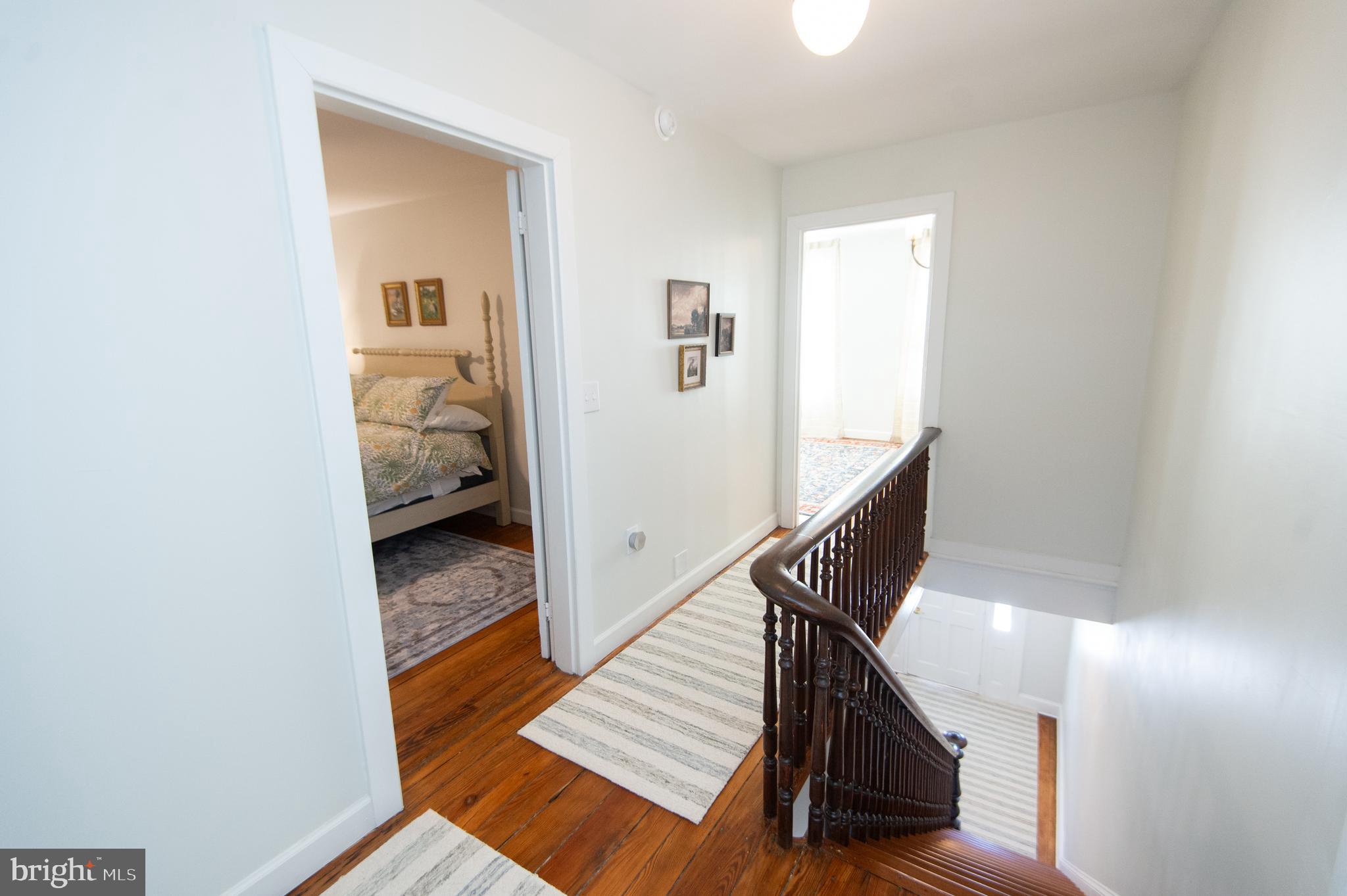 533 South Street Easton, MD 21601 - Photo 27 of 47 a view of a hallway with wooden floor and staircase