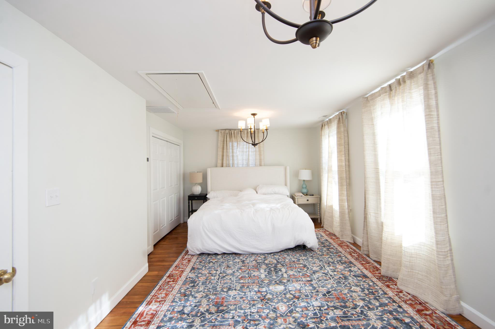 533 South Street Easton, MD 21601 - Photo 28 of 47 a bed room with a bed window and a chandelier