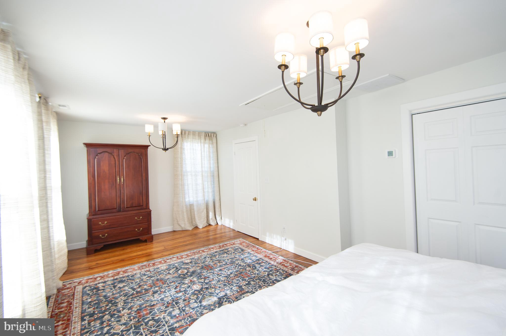 533 South Street Easton, MD 21601 - Photo 32 of 47 a bedroom with a bed and a chandelier