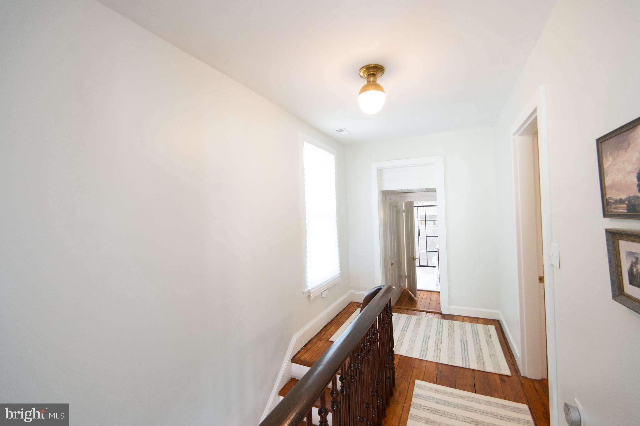 533 South Street Easton, MD 21601 - Photo 33 of 47 a view of a hallway with windows and stairs