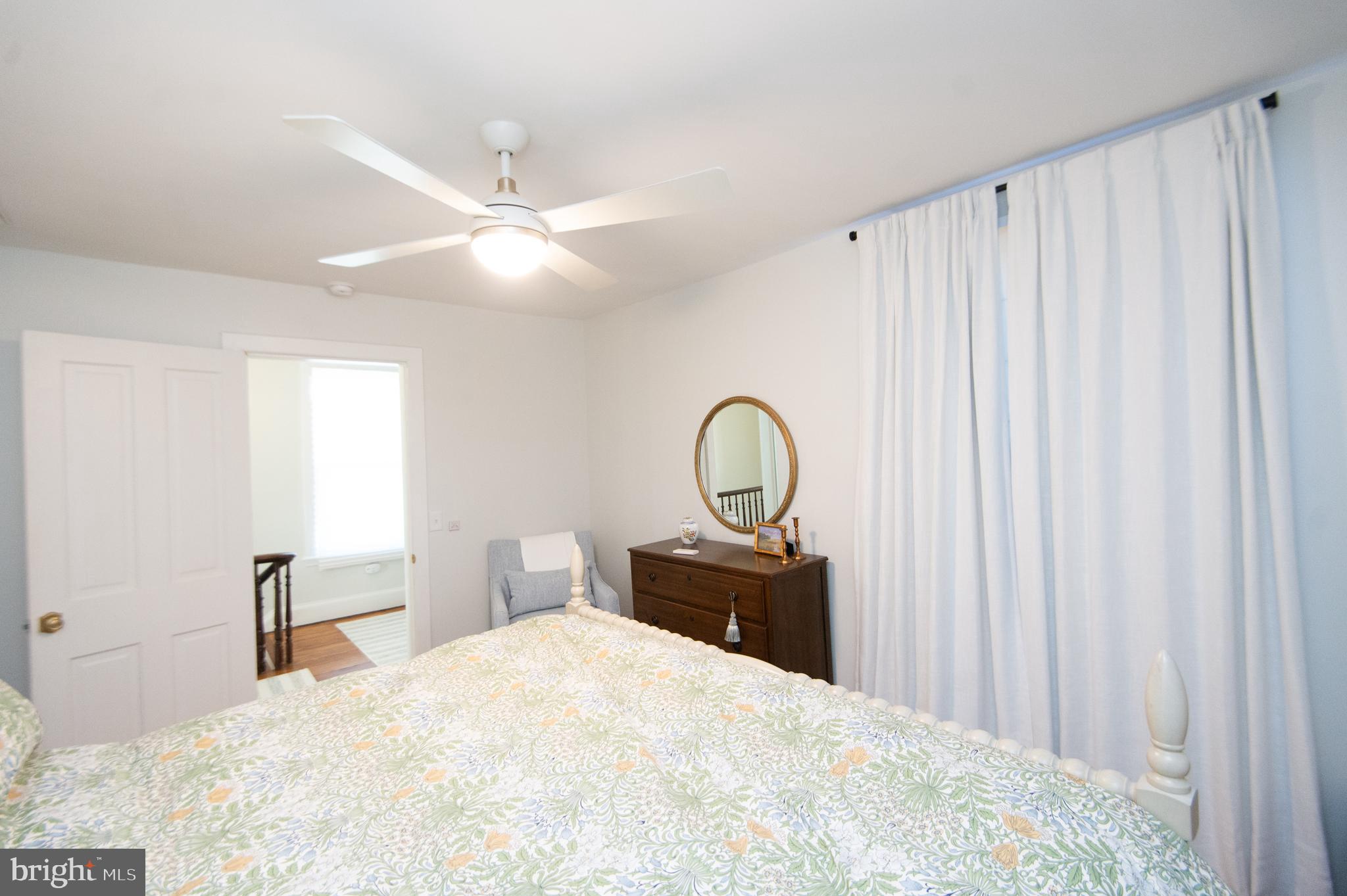 533 South Street Easton, MD 21601 - Photo 36 of 47 a bedroom with a bed and a chandelier