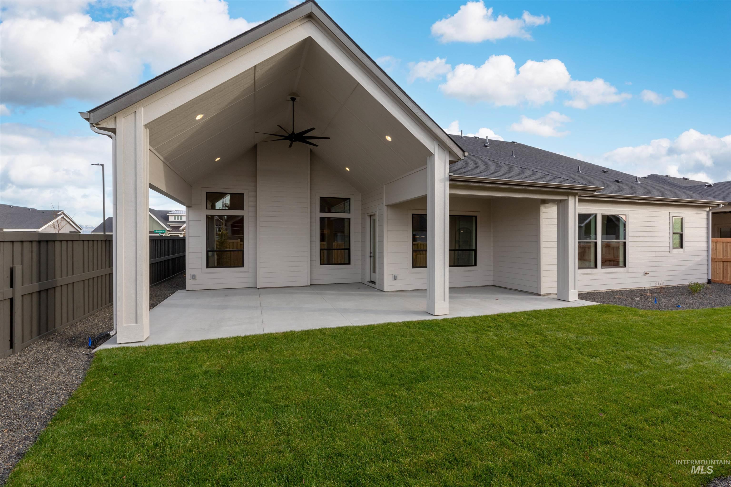 6865 South Utmost Way Meridian, ID 83642 - Photo 29 of 31 Rear view of house with ceiling fan, a patio area, and a fenced backyard
