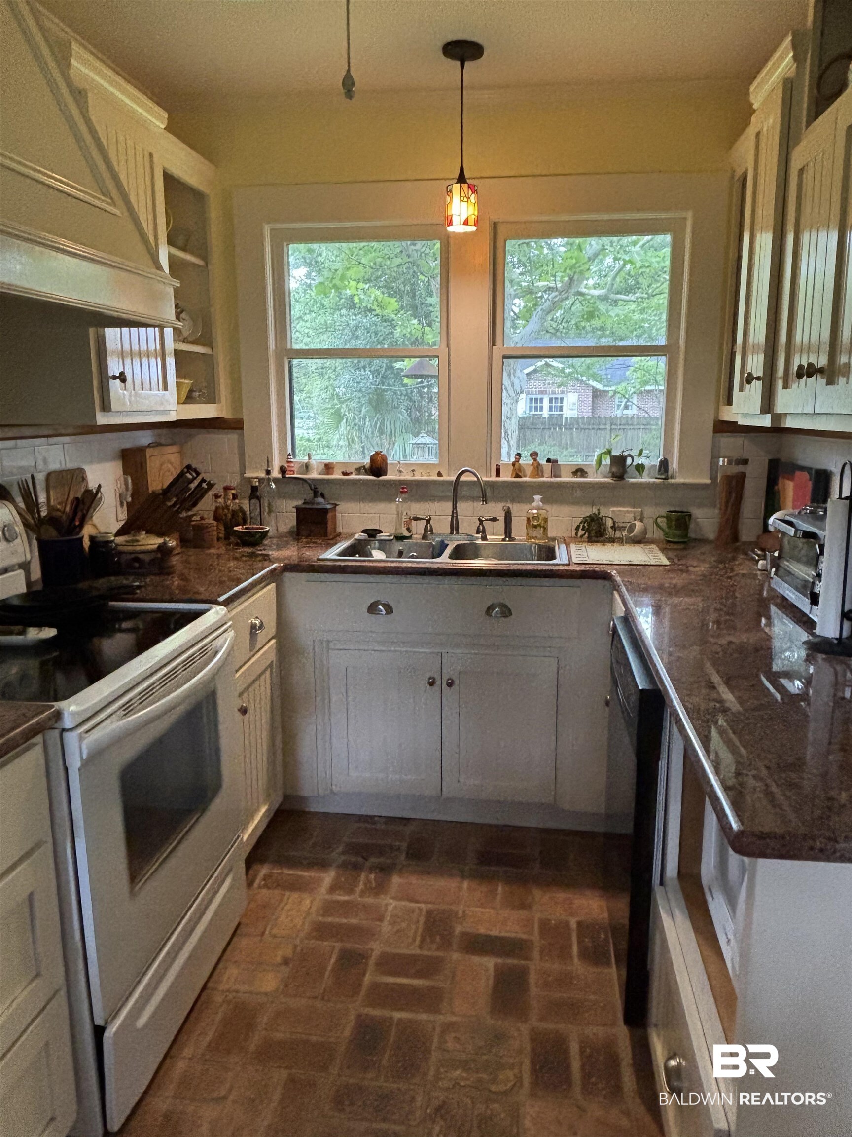 216 West Orange Avenue Foley, AL 36535 - Photo 29 of 37 Kitchen with electric range, custom exhaust hood, a sink, and healthy amount of natural light