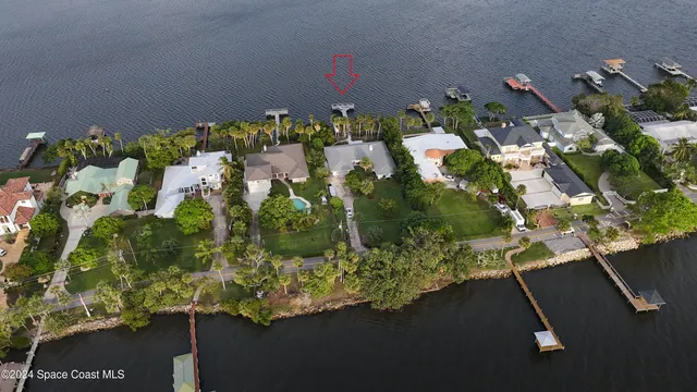 a front view of a house with a yard and a garden