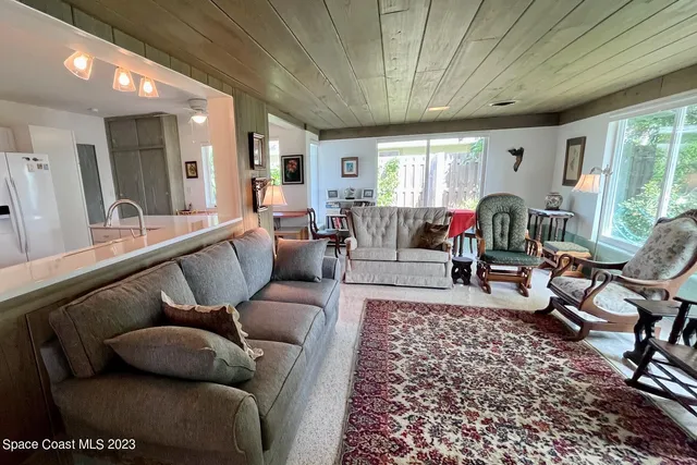 a living room with furniture rug and window