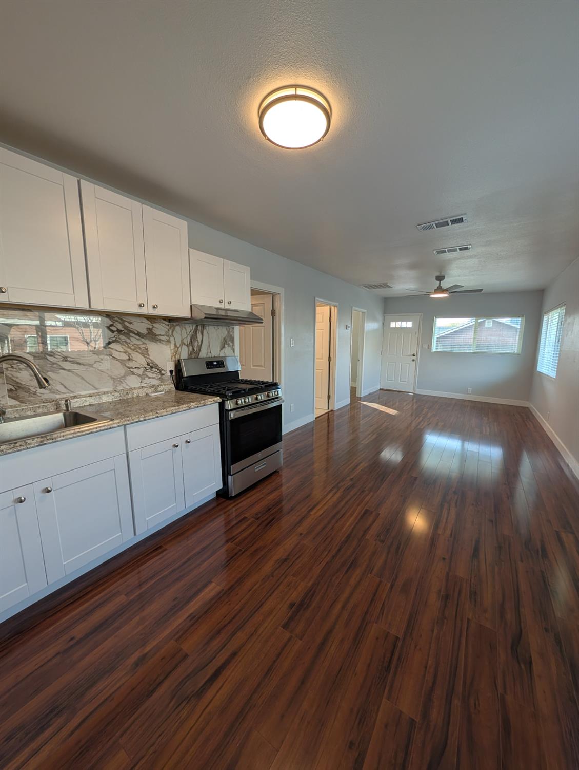 512 Sunset Street Coalinga, CA 93210 - Photo 11 of 24 a open kitchen with cabinets and wooden floor