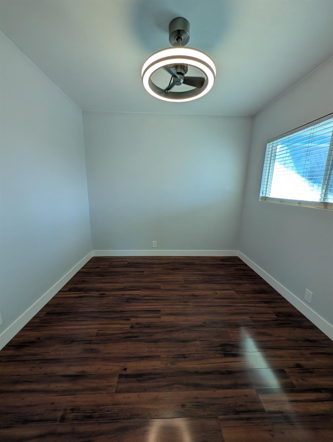 512 Sunset Street Coalinga, CA 93210 - Photo 12 of 24 a view of empty room with wooden floor and fan