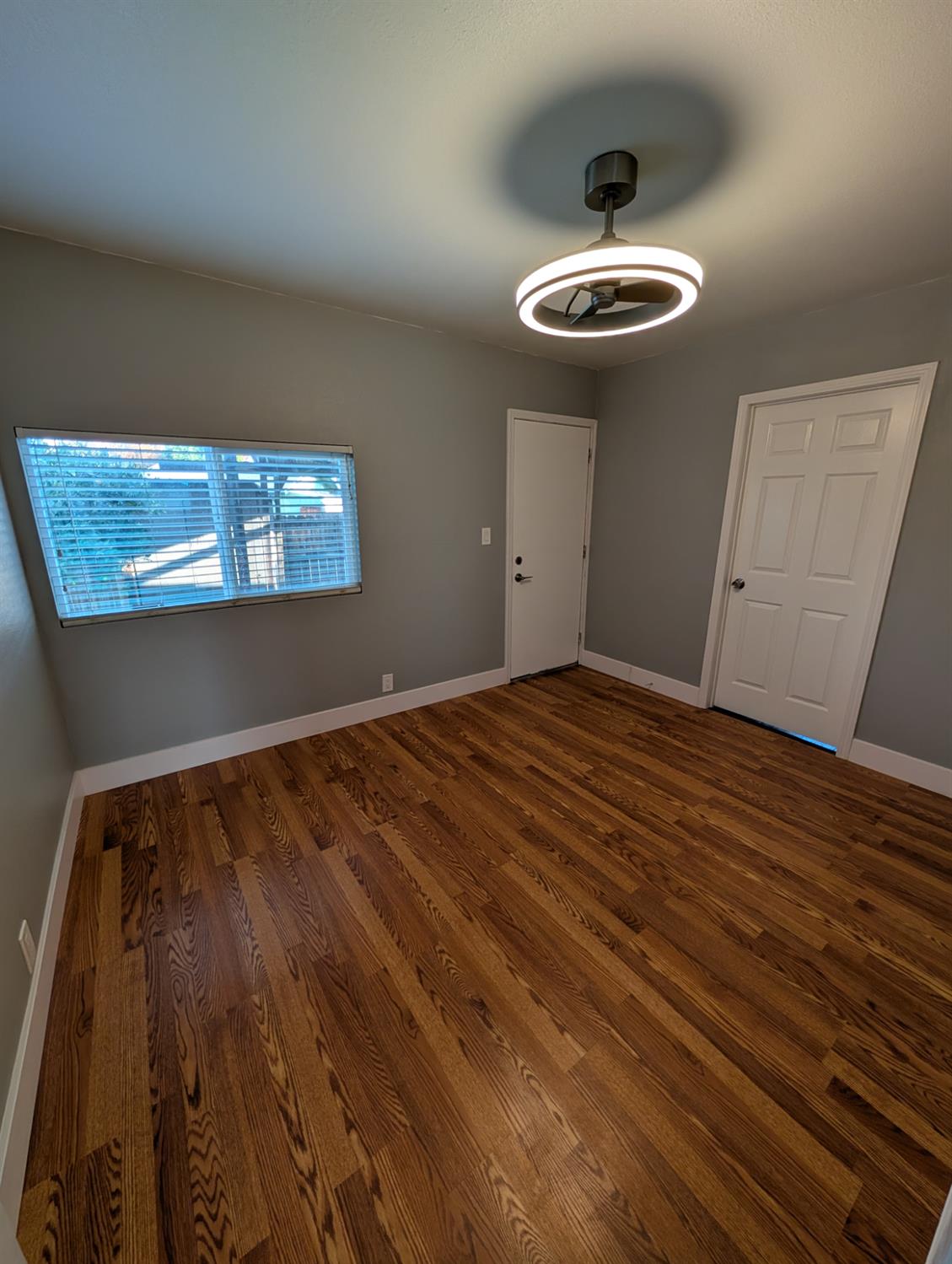512 Sunset Street Coalinga, CA 93210 - Photo 15 of 24 a view of a room with wooden floor and ceiling fan