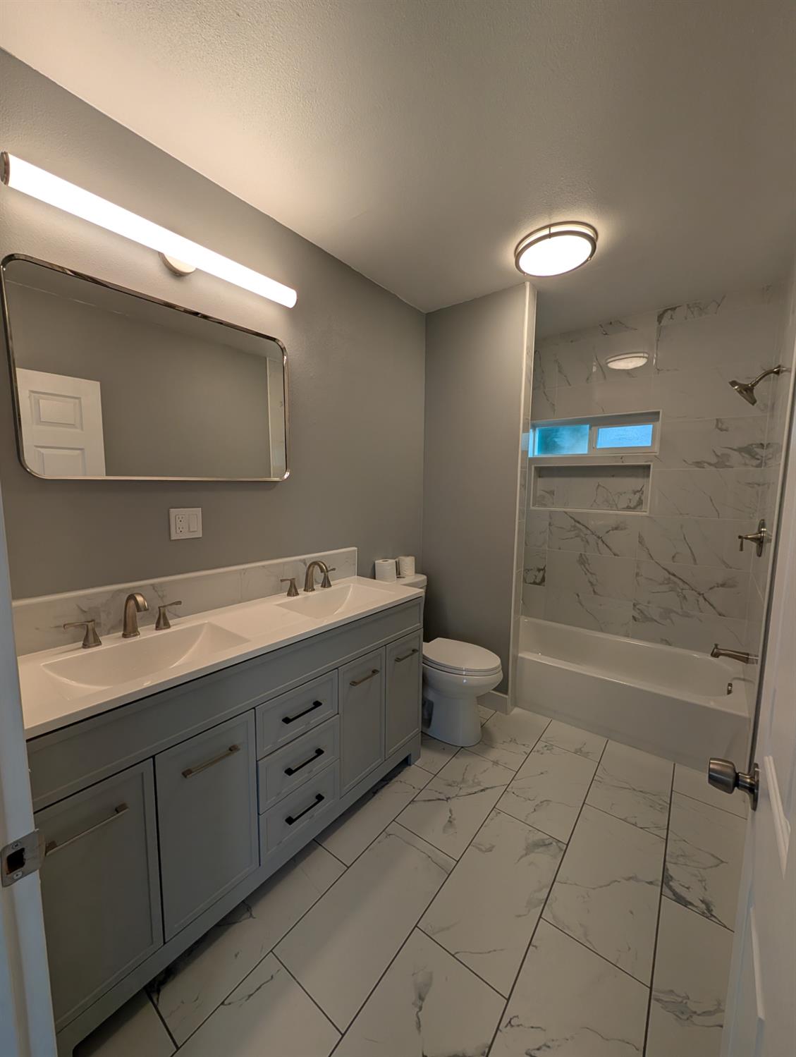 512 Sunset Street Coalinga, CA 93210 - Photo 18 of 24 a bathroom with a double vanity sink a toilet and a mirror