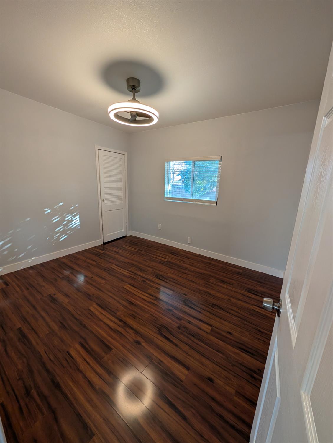 512 Sunset Street Coalinga, CA 93210 - Photo 21 of 24 a view of empty room with wooden floor
