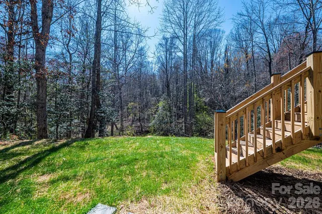 a view of a wooden deck with a yard