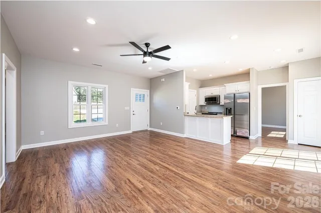 a view of a kitchen with wooden floor and a kitchen