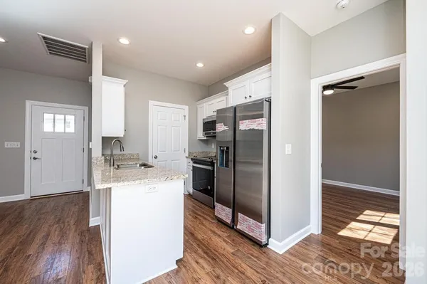 a kitchen with a refrigerator and a sink