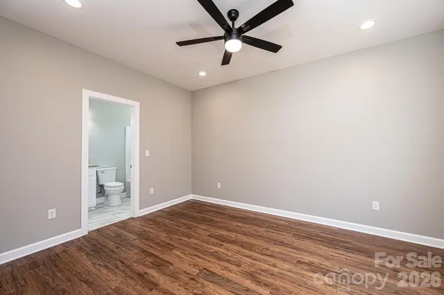 wooden floor in an empty room and a bathroom