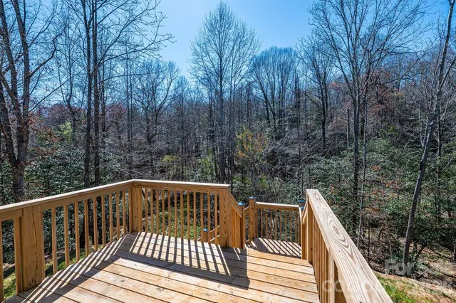 a view of balcony with wooden floor and fence