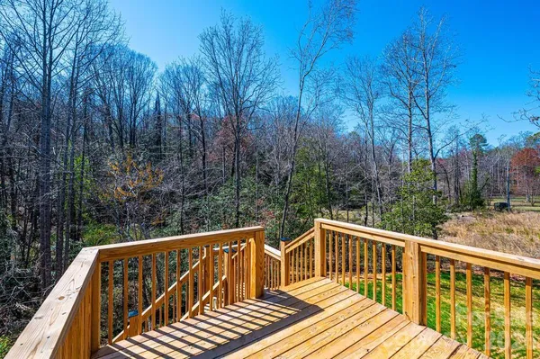 a view of balcony with wooden floor and fence