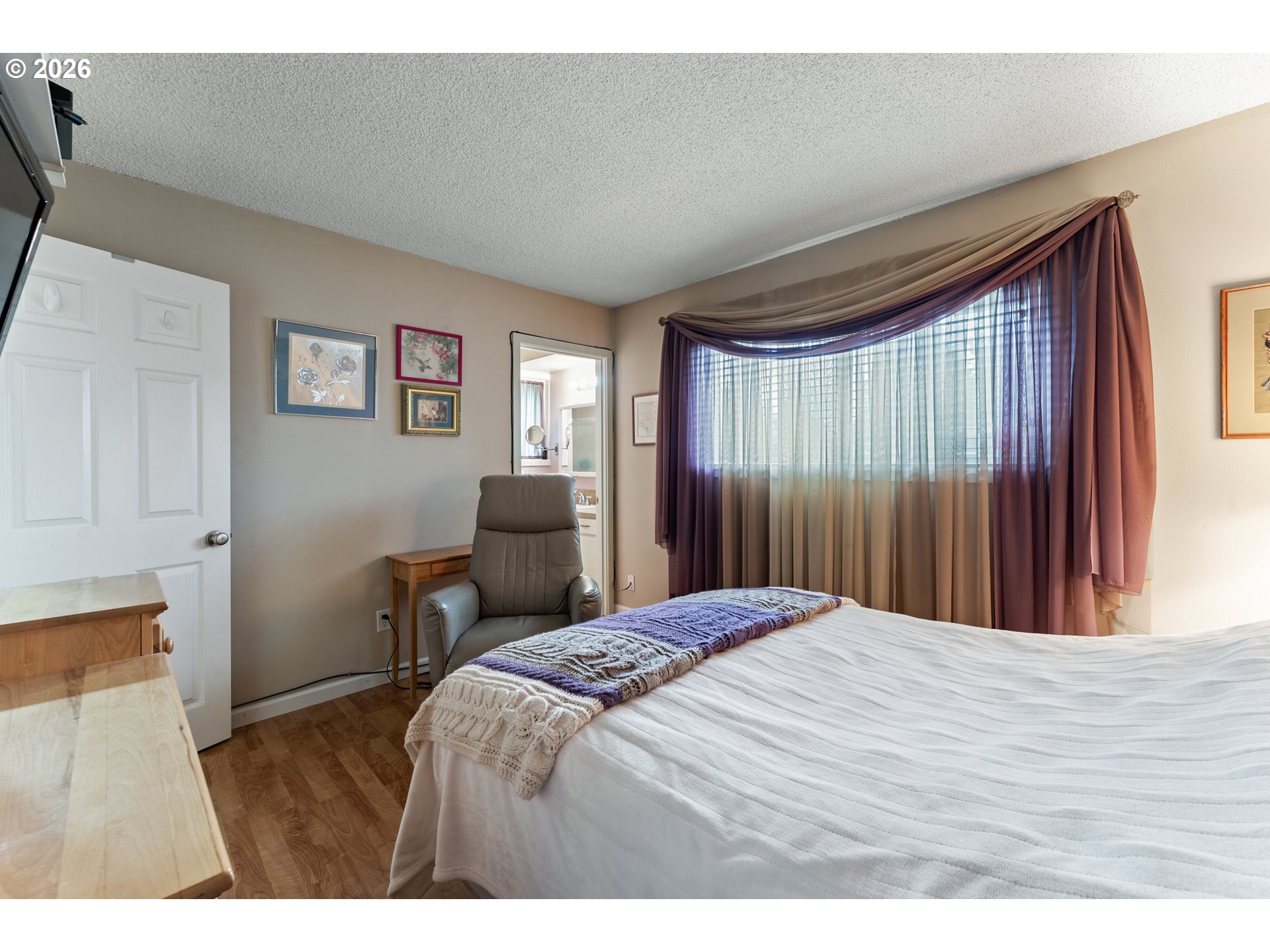 11341 Southwest Springwood Drive Portland, OR 97223 - Photo 17 of 26 a bedroom with a bed table and two window