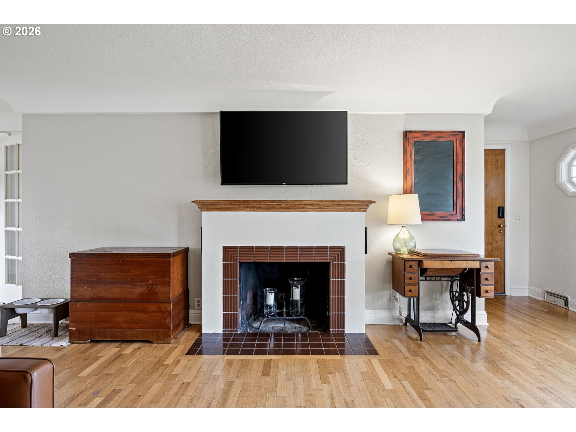 765 Louis Street Eugene, OR 97402 - Photo 8 of 45 a living room with furniture a fireplace and a flat screen tv