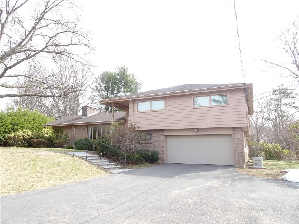 100 Waranoke Road Manchester, CT 06040 - Photo 1 of 1 a front view of a house with a yard and garage